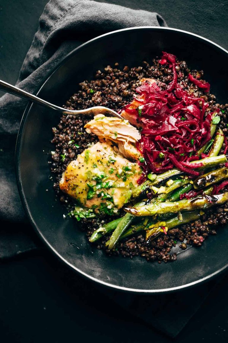 Salmon in a bowl with lentils, sauerkraut, and green beans.